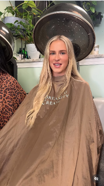 Client under dryer in Dreamsty Creations branded taupe cape